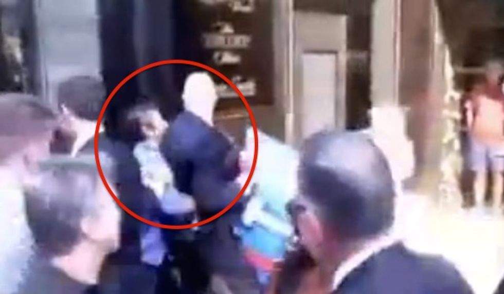 Watch Trump Tower Guard’s Instant Reaction When Protester Rushes Him in Apparent Attempt to Take His Sign Back