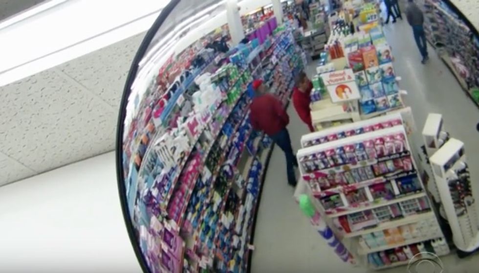Mysterious Man in Red Coat Enters Store, Walks Up to Strangers, and Shocks With Bold Gesture
