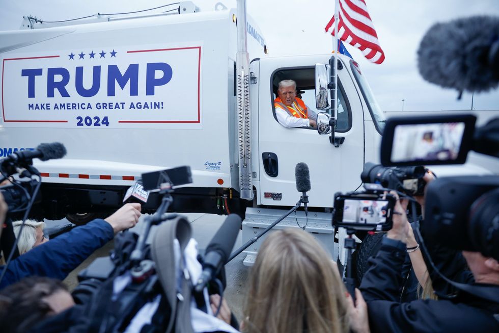 Trump runs media briefing while sitting in massive garbage truck to troll Biden gaffe