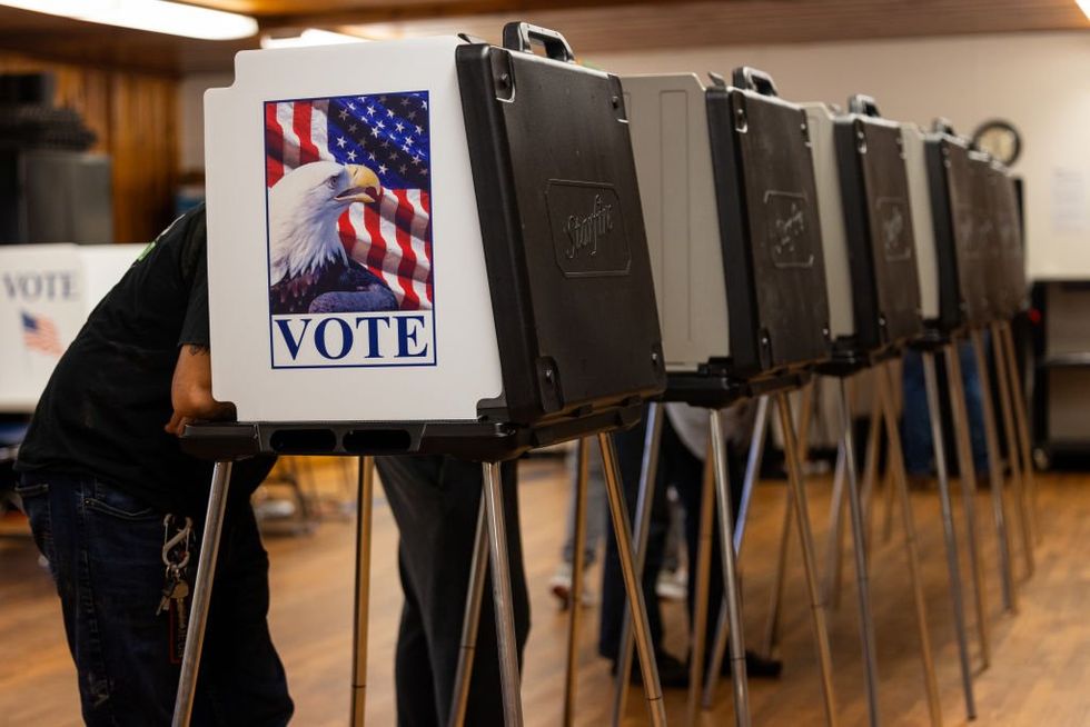 Republicans cry foul after Pennsylvania official who encouraged voters to stay despite long lines arrested at polling station