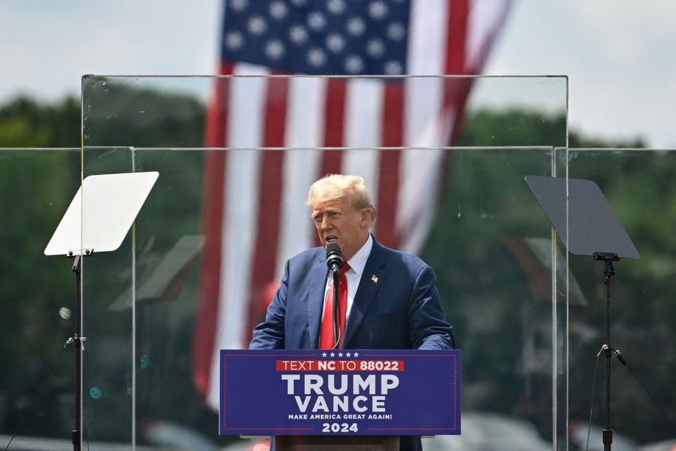 Trump leaves bulletproof glass to check on, hug supporter who fainted at first outdoor rally since assassination attempt